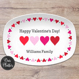 Happy Valentine's Day platter with hearts around the border and family name at the bottom. Four pink and red hearts in center