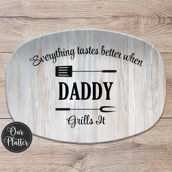 everything tastes better when daddy grills it serving platter on white wood with fork and spatula